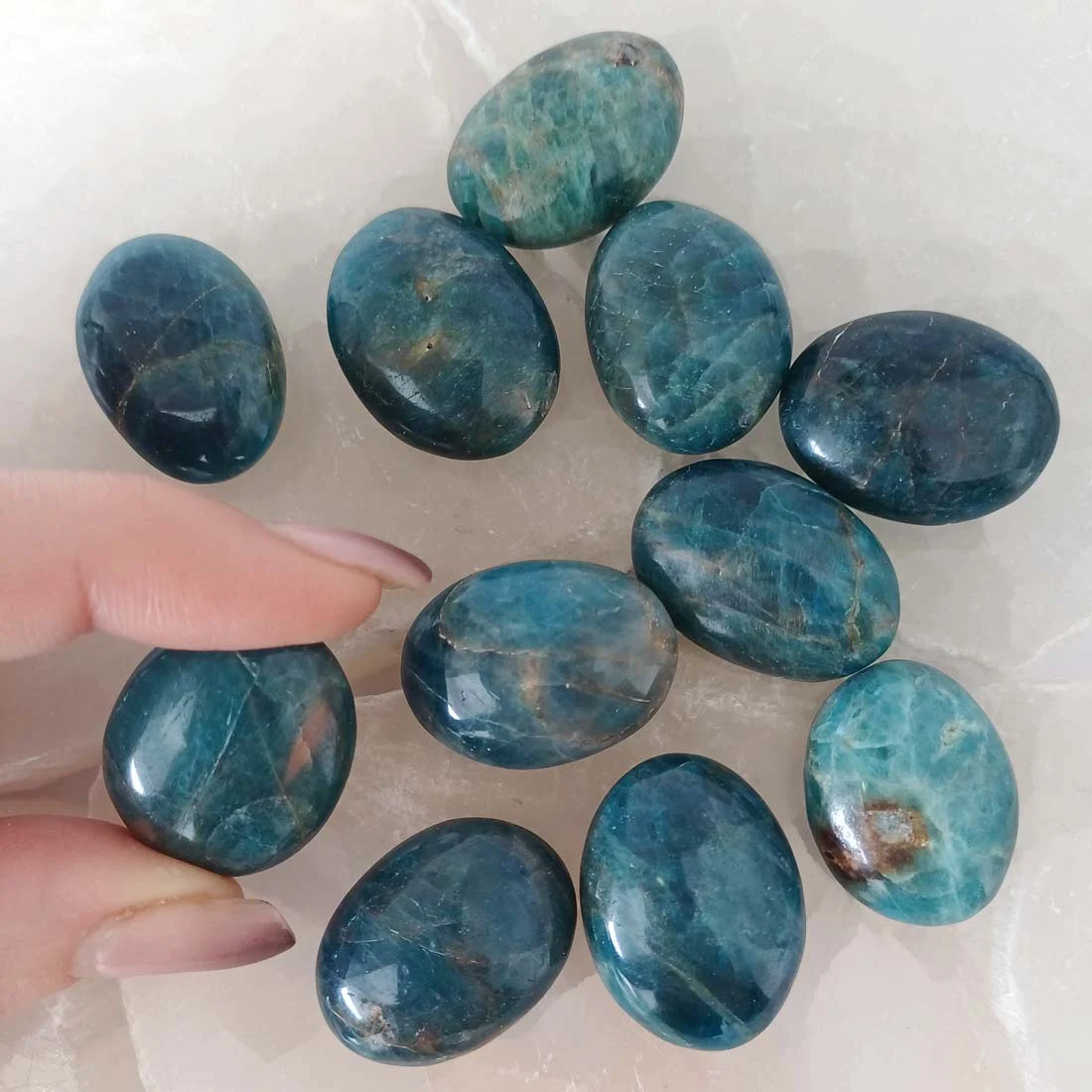 Polished Apatite tumbled stone with vibrant blue tones and slight translucency, natural crystal associated with clarity, focus, and motivation.