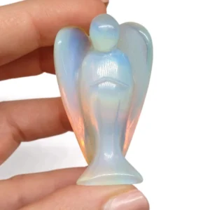 Carved Opal Glass Angel figurine with luminous, iridescent tones reflecting soft colors in light.