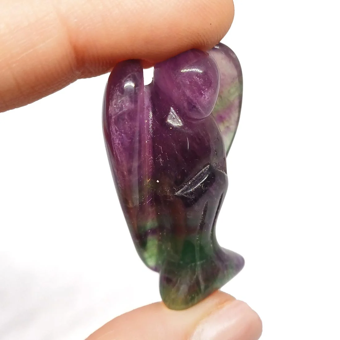Carved Rainbow Fluorite Angel figurine, small and transparent, showing layered green, purple, and blue tones.