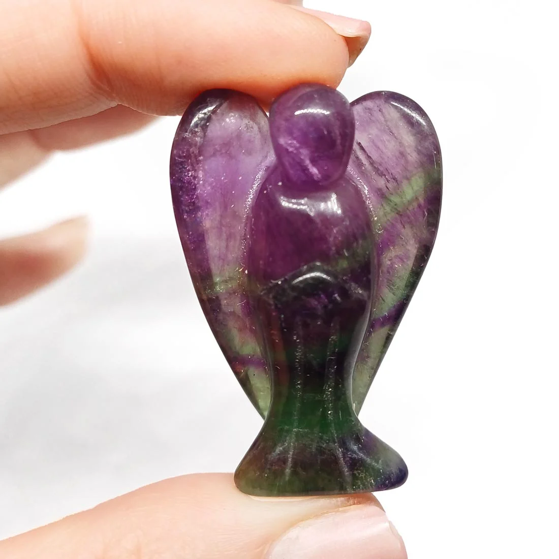 Carved Rainbow Fluorite Angel figurine, small and transparent, showing layered green and purple tones