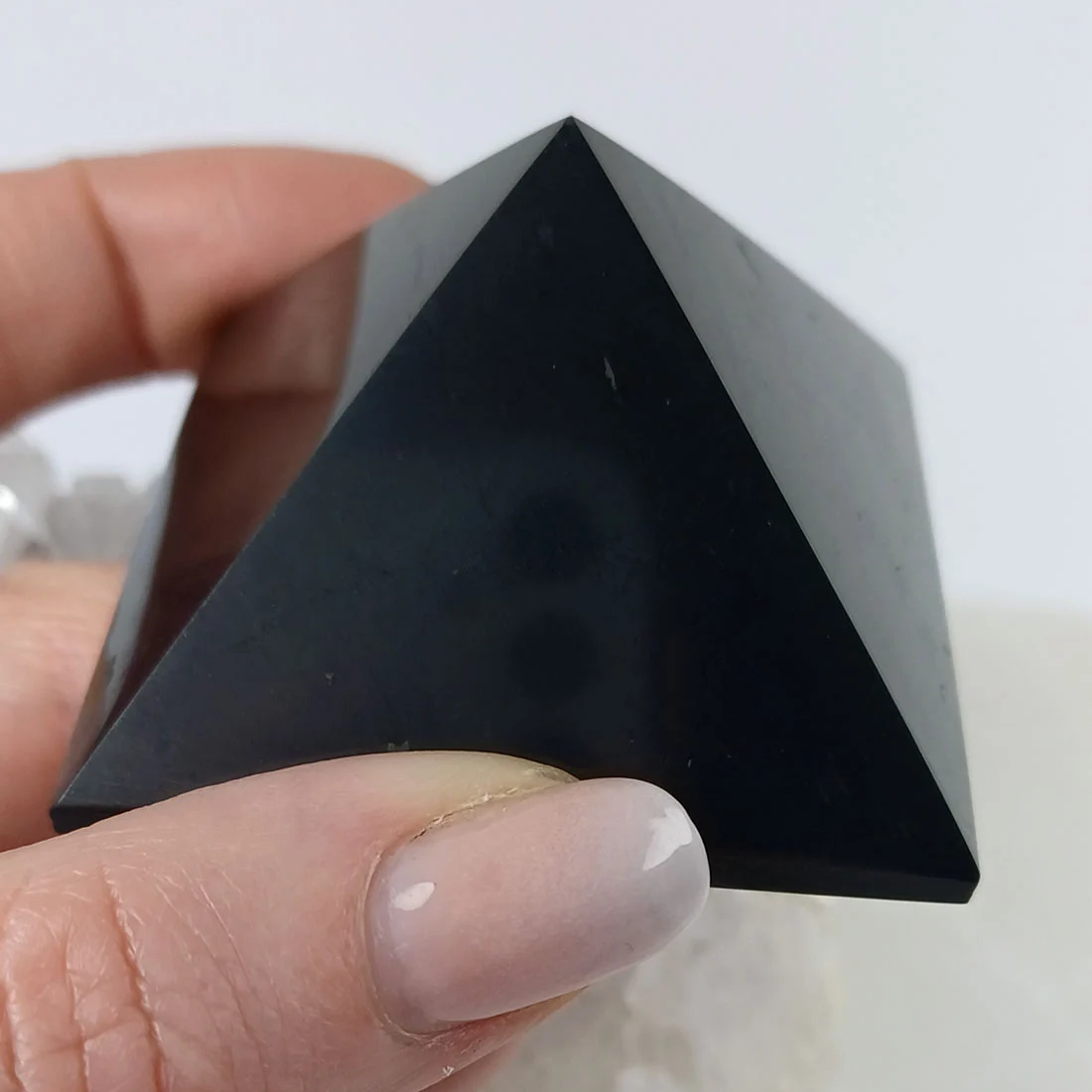 Shungite pyramid carved from natural black shungite stone