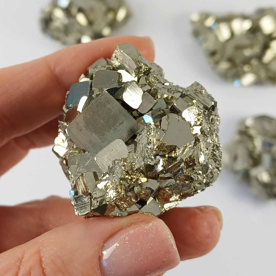 Pyrite crystal with large natural formations, metallic surface, and cubic growth patterns.