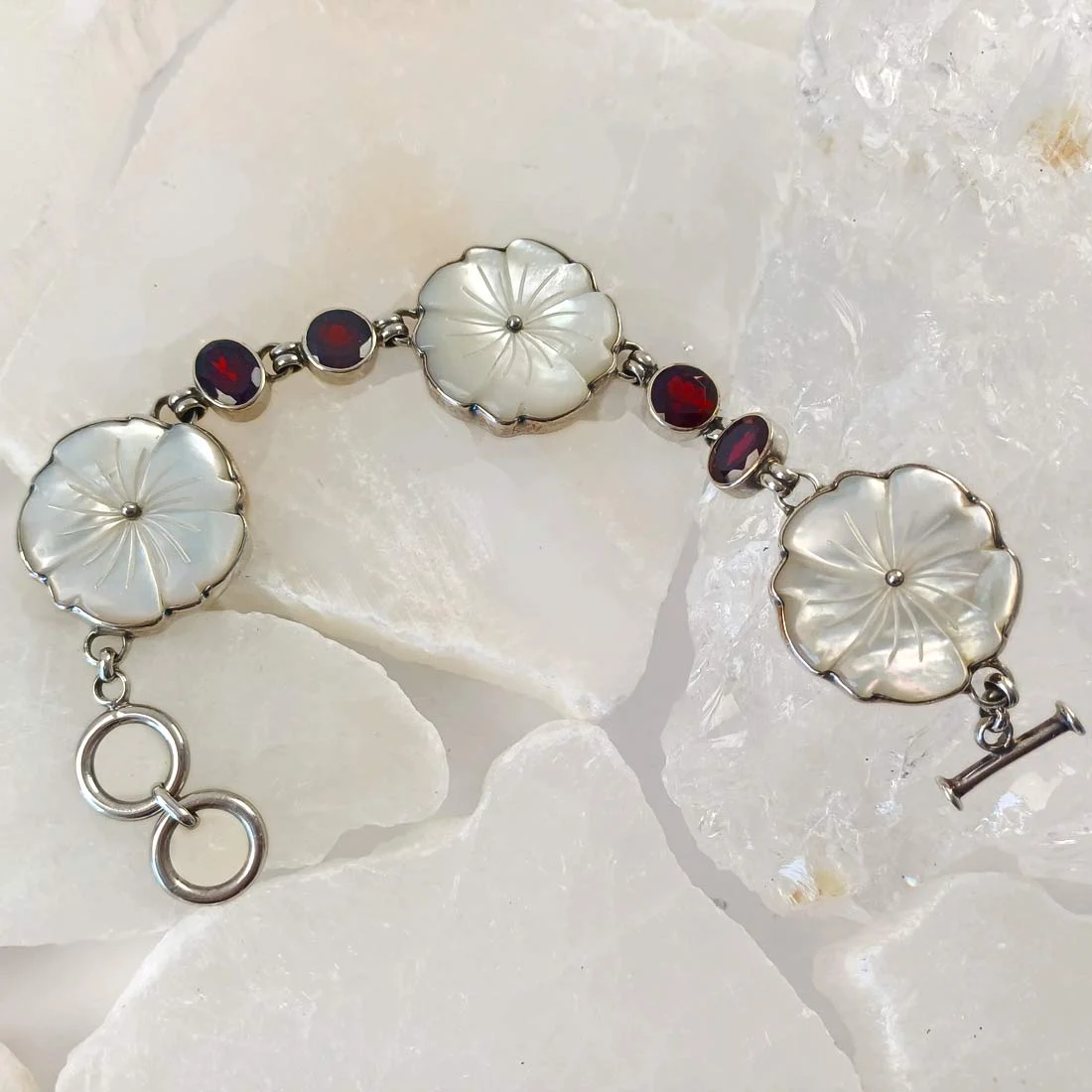 White shell blossoms and garnet silver bracelet