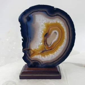 Natural agate slice rock on a removable wooden base.