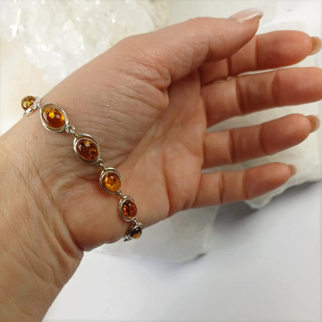 Natural amber bracelet set with 925 sterling silver elements, showing warm yellow tones and organic internal inclusions.