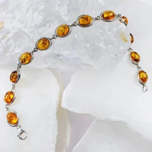 Natural amber bracelet set with 925 sterling silver elements, showing warm yellow tones and organic internal inclusions.