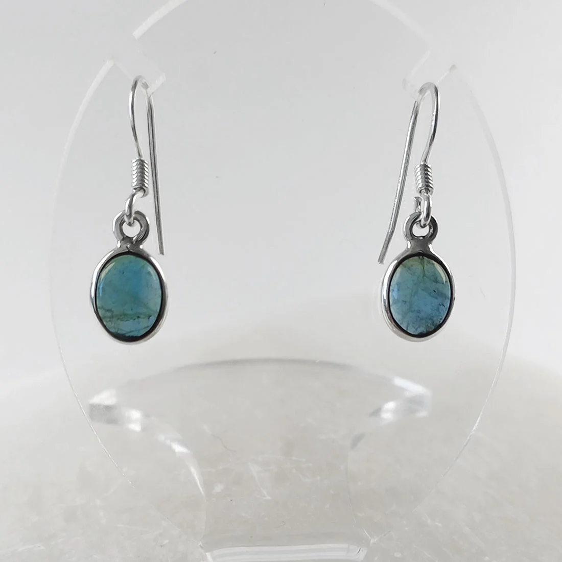 Natural apatite crystal small oval earrings in 925 sterling silver, showing blue-green tones and smooth polished surface.