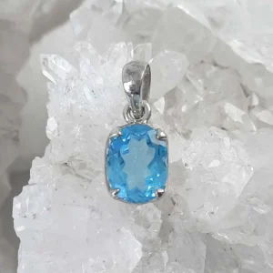 Oval faceted Blue Topaz pendant featuring a natural blue crystal set in 925 sterling silver