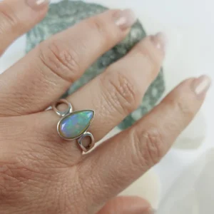 Opal drop shape ring with natural crystal set in 925 sterling silver, showing color play and polished teardrop design.