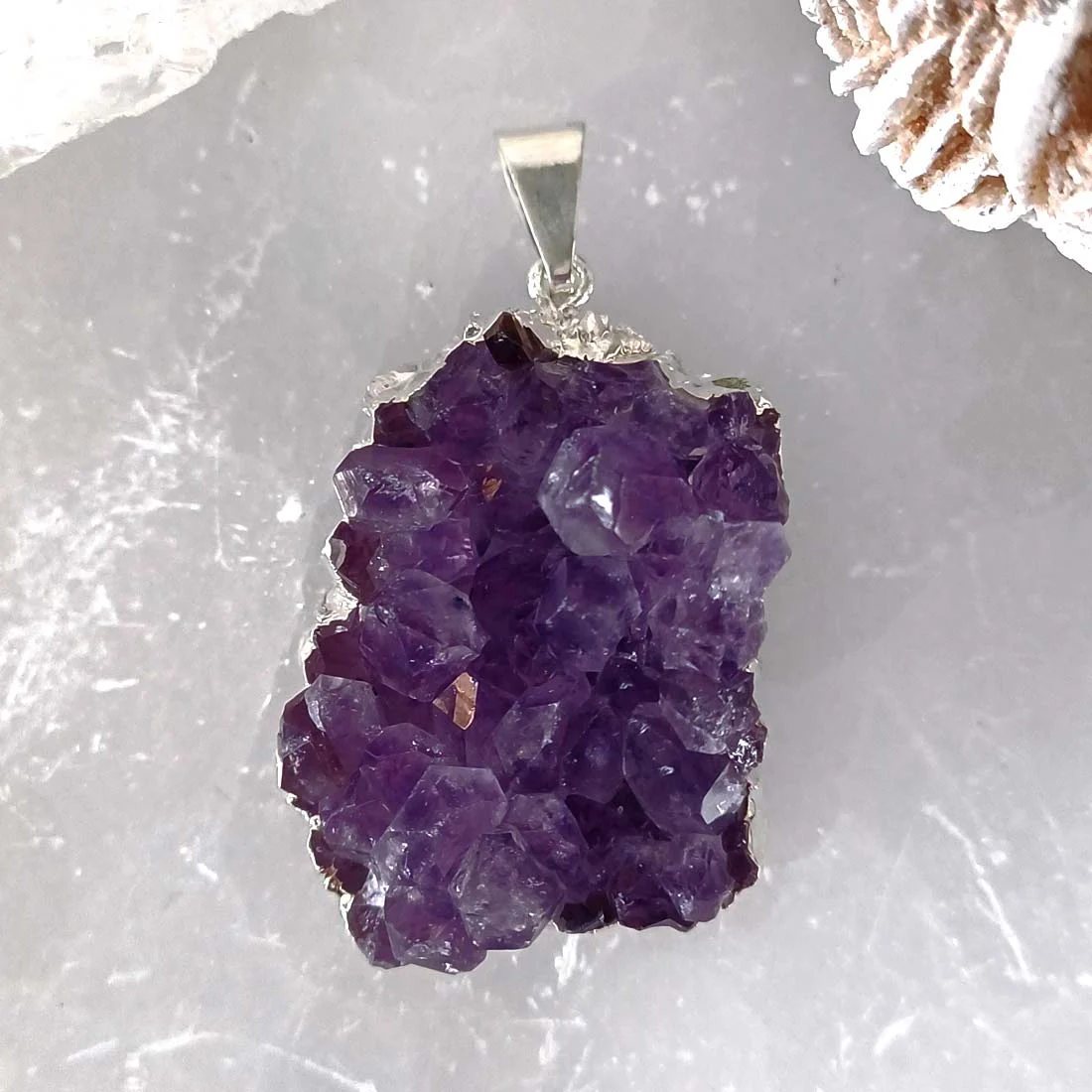 Natural Amethyst druzy crystal pendant with silver-plated bail.