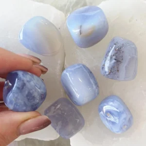 Polished Blue Lace Agate tumbled stone with soft blue and white banding, natural crystal known for calming energy and communication support.