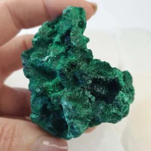 Fibrous malachite from Congo with deep green banding. A copper carbonate crystal formed in natural deposits, valued for its structure and geological origin.