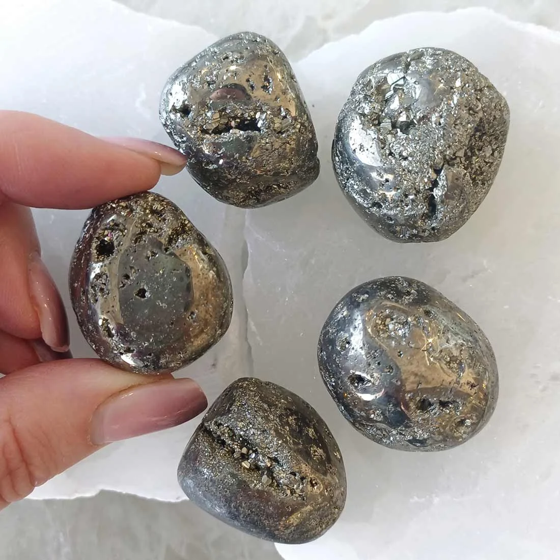 Polished Pyrite tumbled stone with metallic golden shine and reflective surface, natural crystal associated with confidence and prosperity energy.