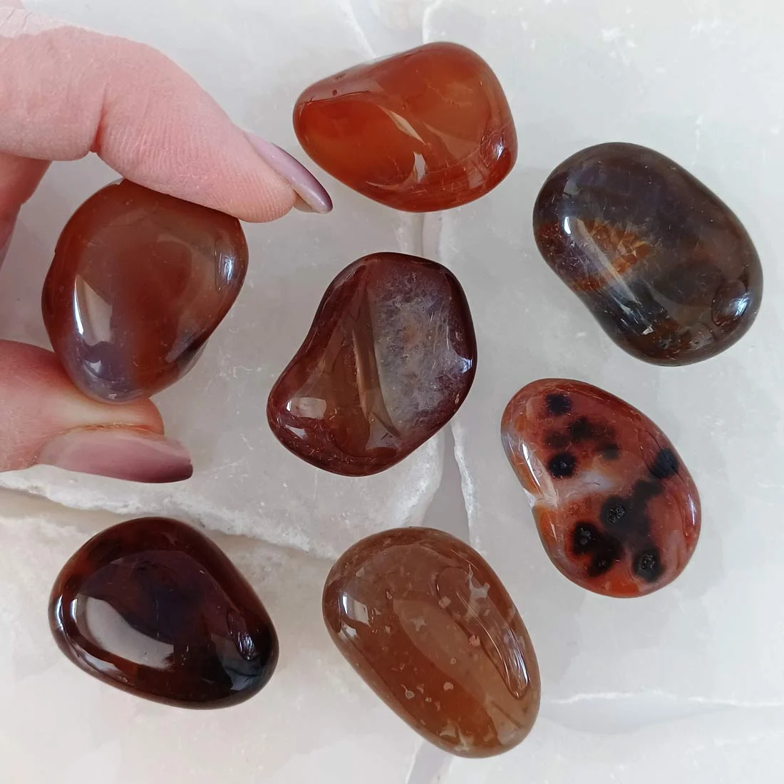 Polished Brown Agate tumbled stone with warm caramel and chocolate tones, natural chalcedony crystal associated with grounding and stability.