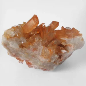 Natural Tangerine Quartz crystal cluster with orange iron-coated quartz points on raw mineral base