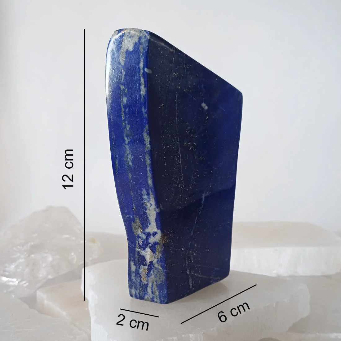 Polished self-standing Lapis Lazuli mineral from Pakistan with deep blue color and natural pyrite inclusions.