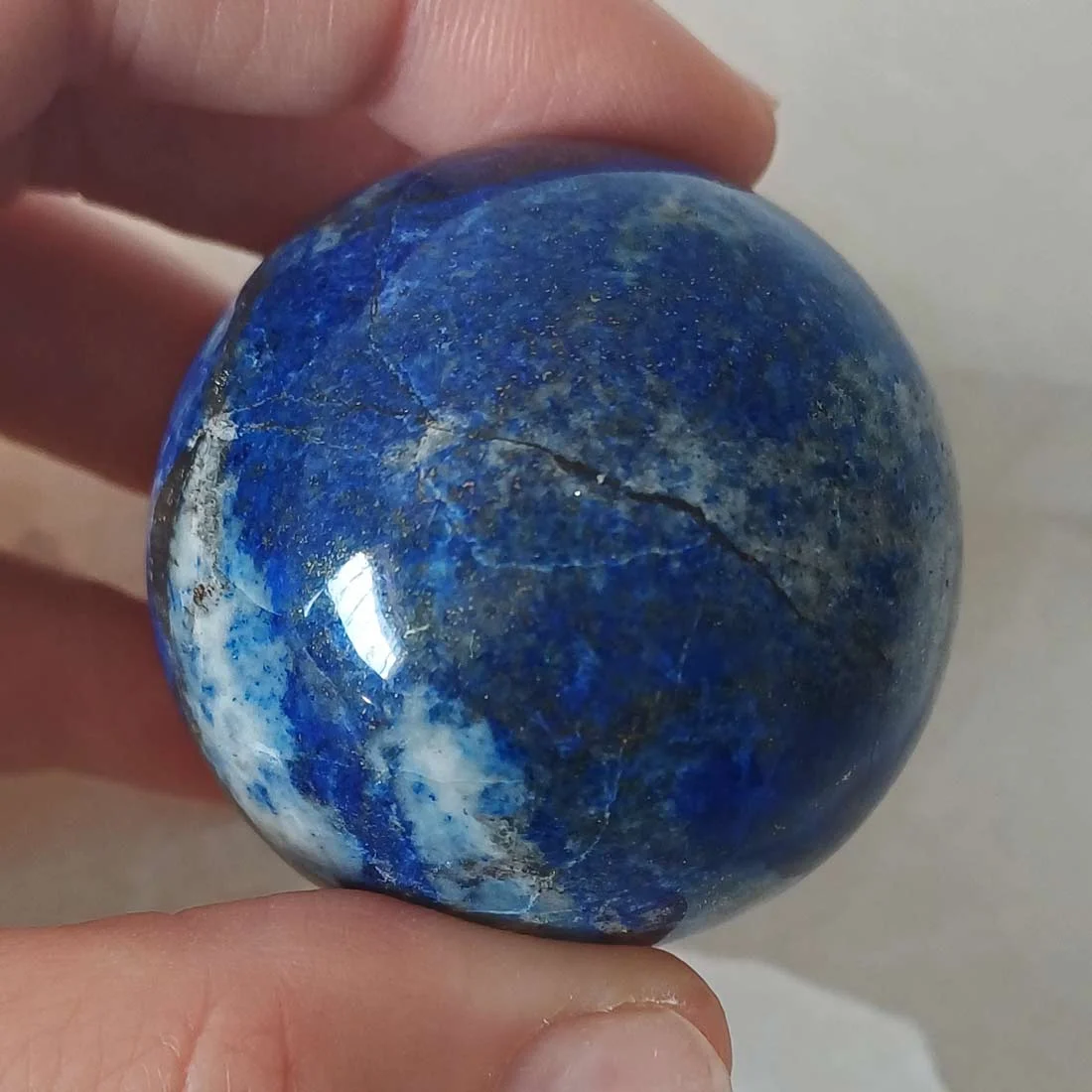 olished Lapis Lazuli sphere with deep blue color and natural pyrite inclusions.