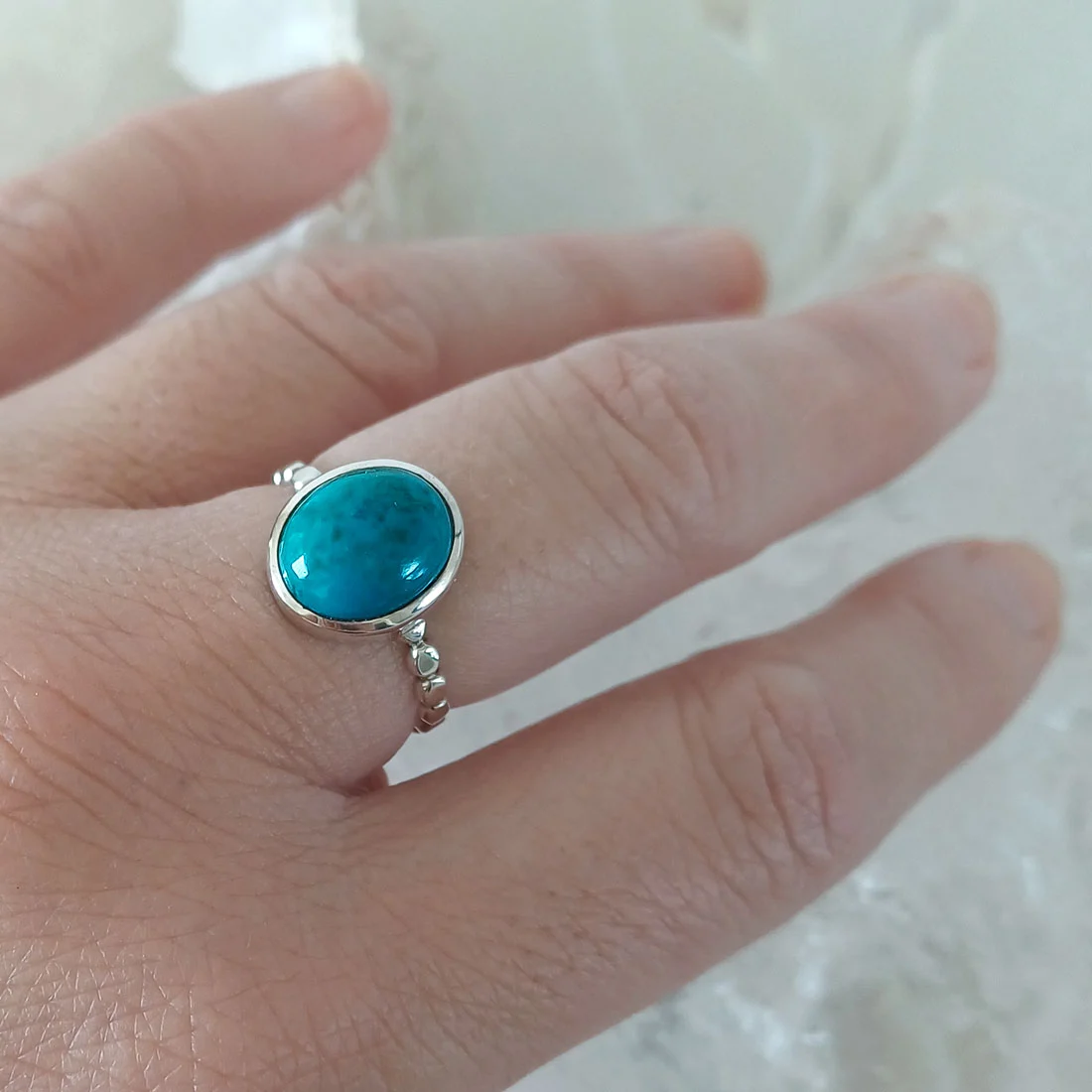 Natural chrysocolla oval ring set in 925 sterling silver.